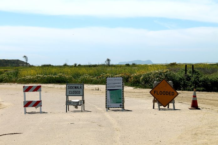 signs at a park in california indicating flooding